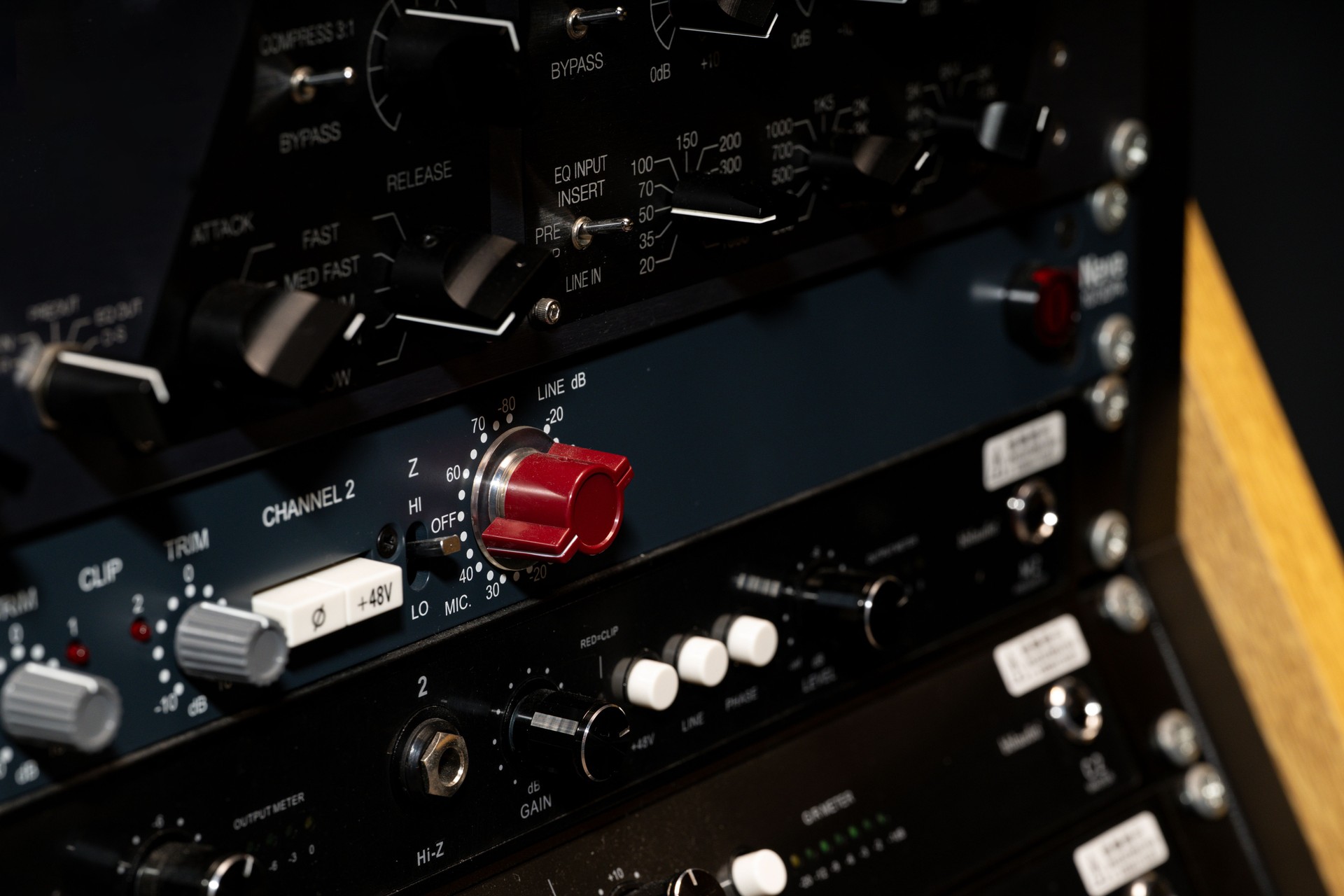 Close-up of Professional Audio Mixer Control Panel Featuring Knobs, Switches, and Channel Settings for Sound Engineering and Music Production