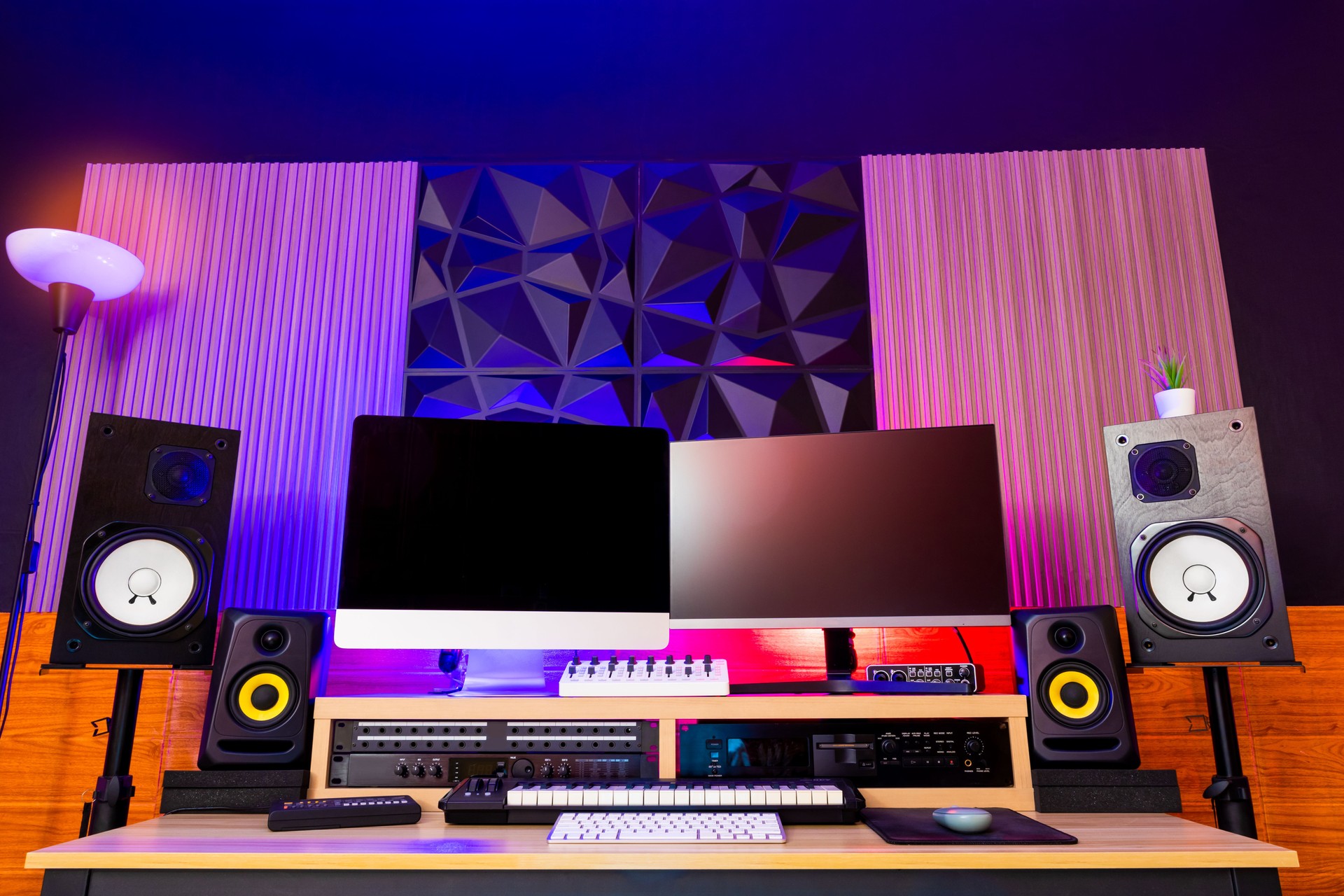 music production studio interior showing modern wall diffusers material installation. desktop computer, studio monitor, audio equipment midi keyboard on desk