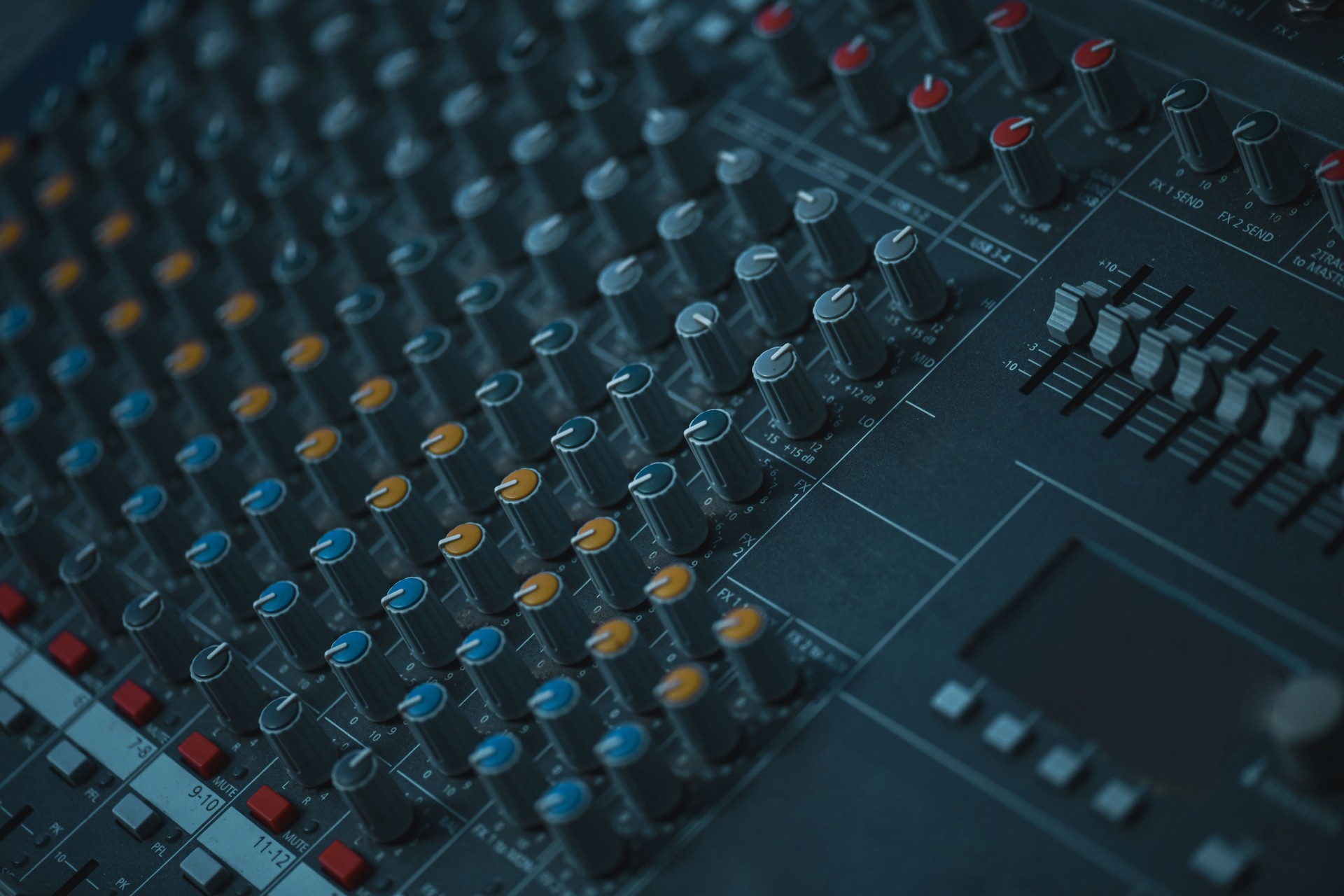 Close View Of A Professional Audio Mixer With Knobs, Faders, And Control Panels In Studio