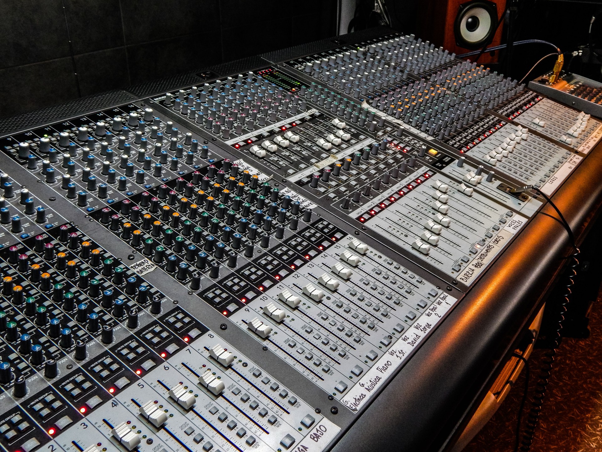 Big audio mixer with a lot of knobs and faders